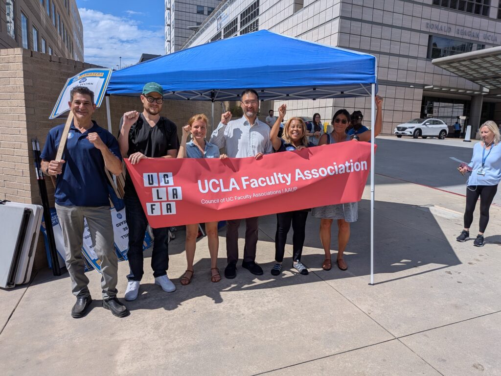 A number of faculty holding the UCLA FA banner at a Teamsters rally.
